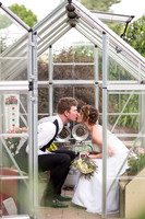 Photo of bride and groom kissing inside a tiny greenhouse on their wedding day in Lancaster, PA
