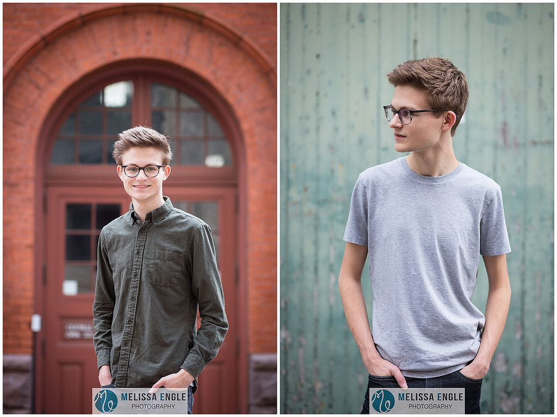 Creative senior portrait of a guy wearing glasses in an urban setting in downtown Lancaster City.