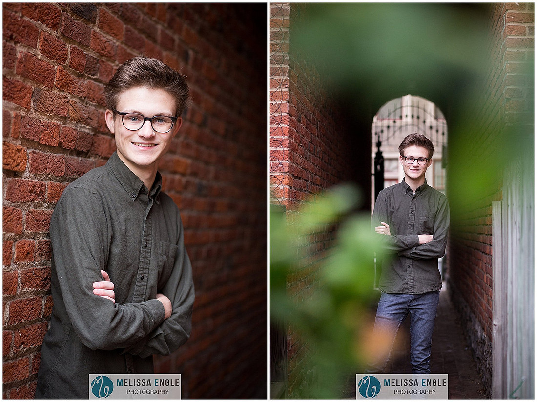 Creative senior portrait of a guy wearing glasses in an urban setting in downtown Lancaster City.