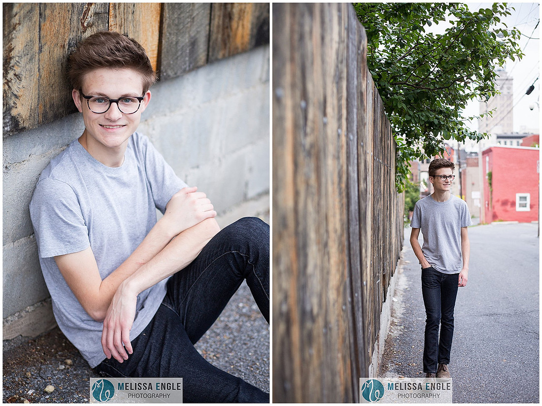 Creative senior portrait of a guy wearing glasses in an urban setting in downtown Lancaster City.
