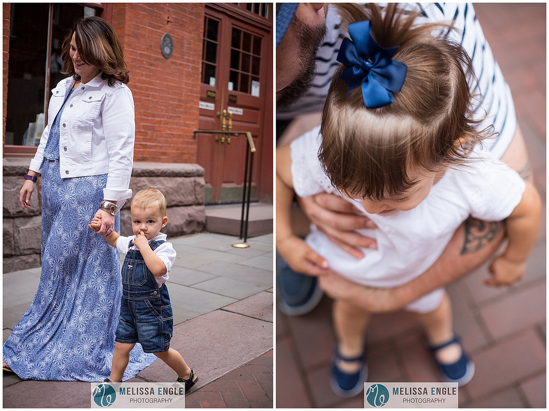 Candid family photo of parents with twins in downtown Lancaster City, PA.