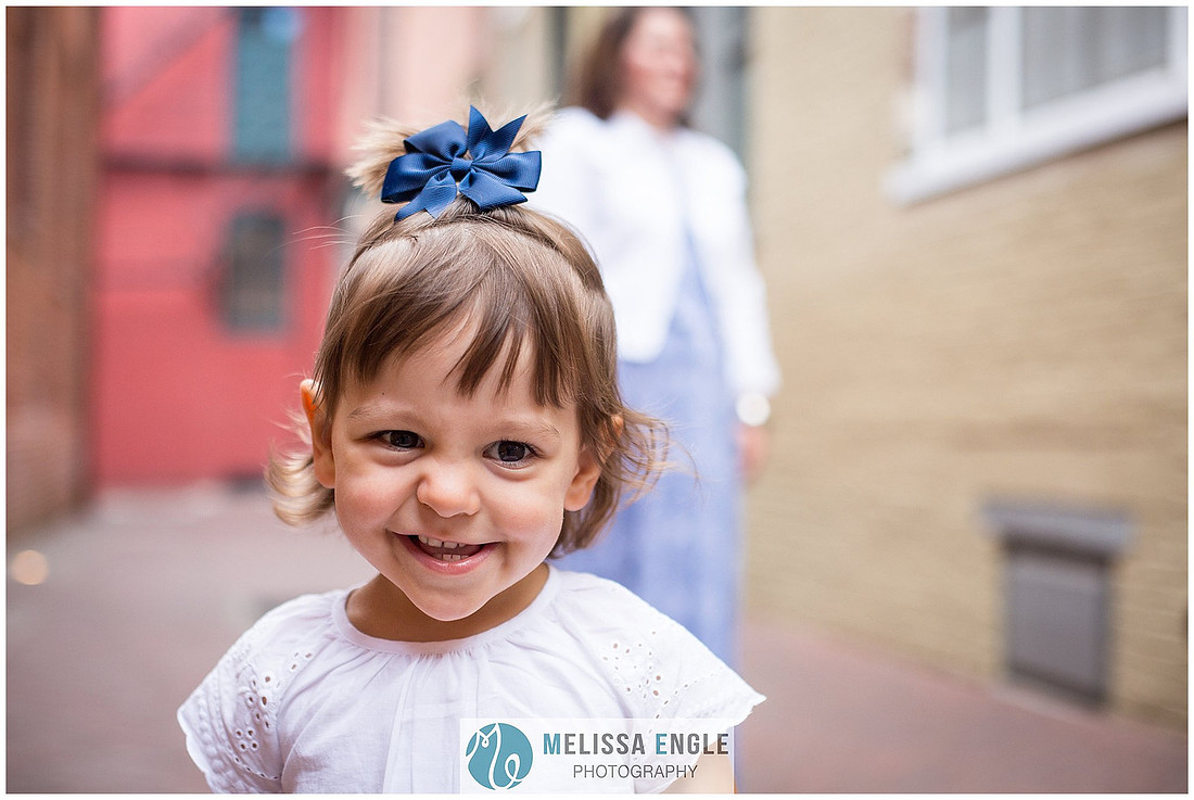 Candid family photo of parents with twins in downtown Lancaster City, PA.