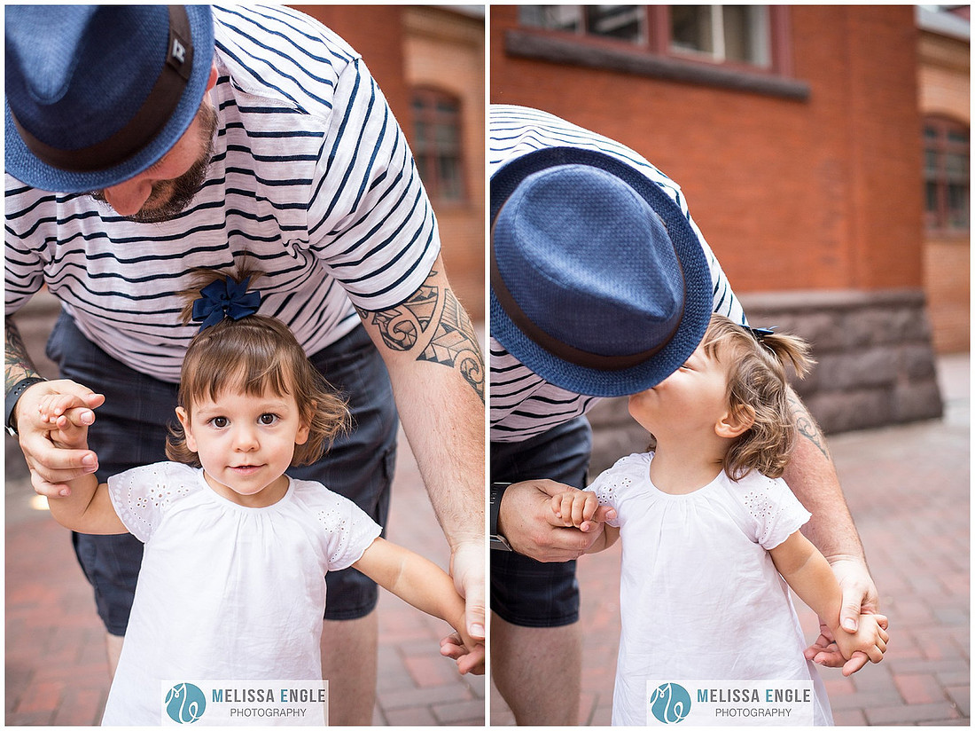 Candid family photo of parents with twins in downtown Lancaster City, PA.