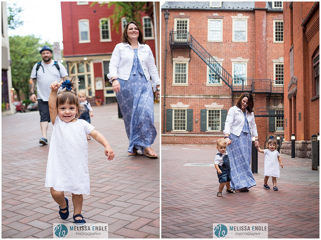 Candid family photo of parents with twins in downtown Lancaster City, PA.