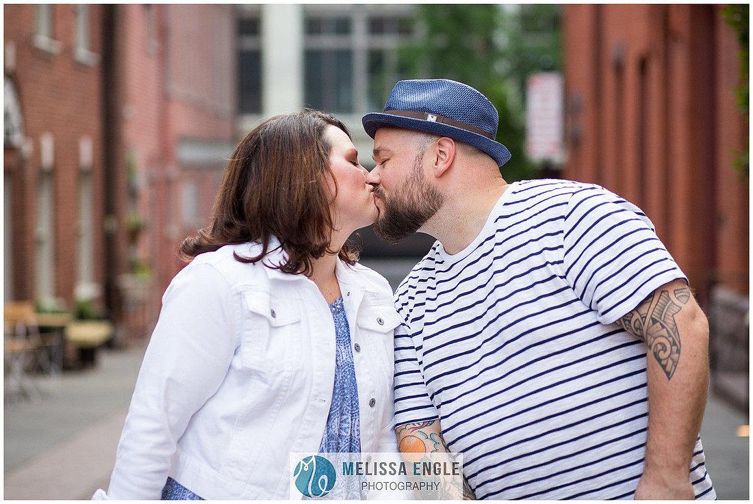 Candid family photo of parents with twins in downtown Lancaster City, PA.