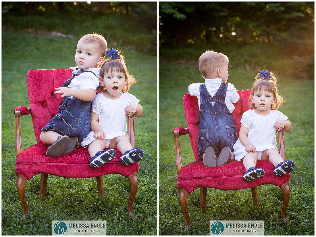 Photo of two-year-old twins sitting on a red chair in Musser Park.