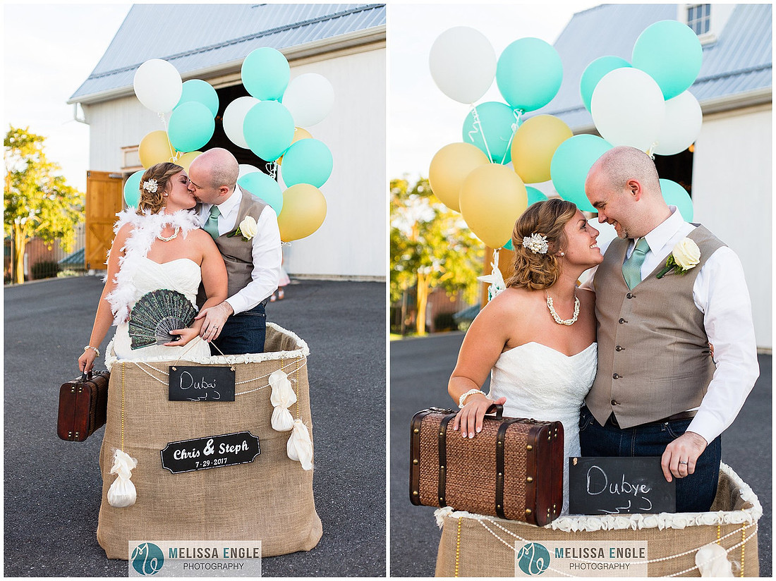 Photo of a bride and groom kissing inside the basket of a hot air balloon theme photo booth at Springside Barn in East Earl, PA.