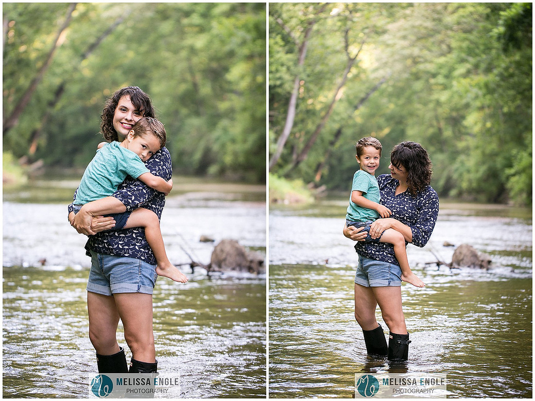 Photo of a mother holding her son in the middle of a creek.