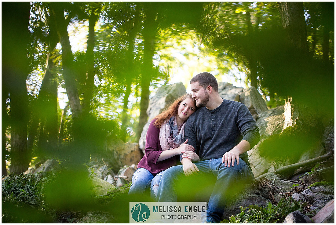 Engagement photo of a couple in the forest at Money Rocks County Park.