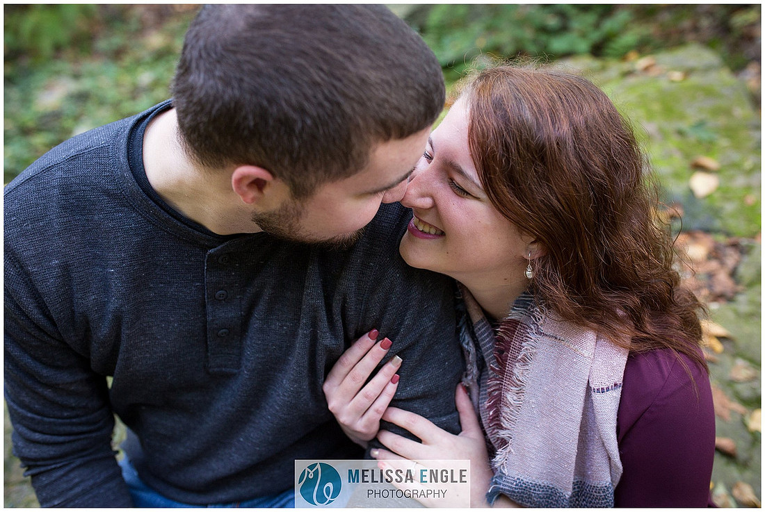Engagement photo of a couple in the forest at Money Rocks County Park.