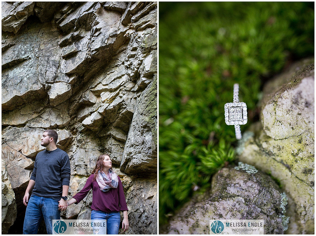 Engagement photo of a couple in the middle of the woods surrounded by trees, rocks and sunlight at Money Rocks County Park.