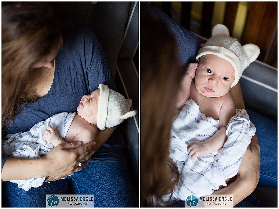 Photo of a young brunette mother holding her newborn infant baby boy.