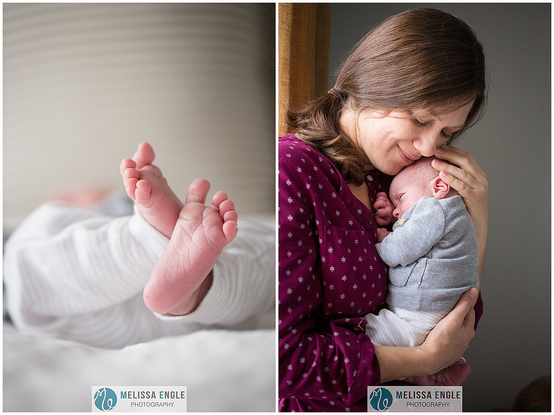 Photo of a mother wearing purple cuddling her newborn baby boy beside a window.
